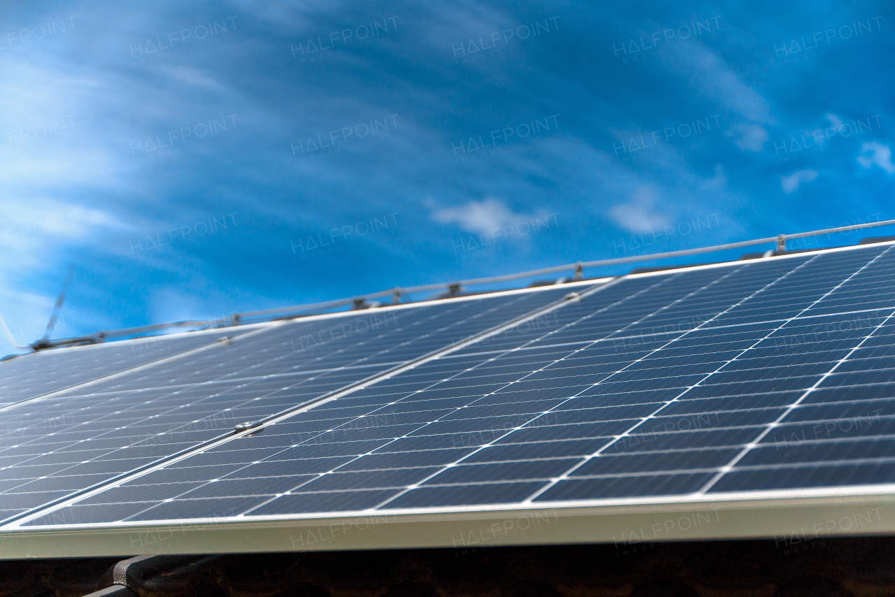 Close-up of solar photovoltaic panels on a roof, alternative energy, saving resources and sustainable lifestyle concept.