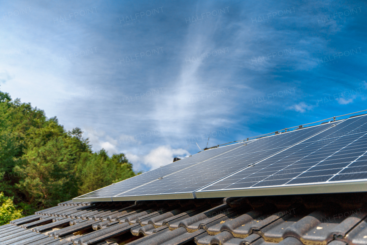 Close-up of solar photovoltaic panels on a roof, alternative energy, saving resources and sustainable lifestyle concept.