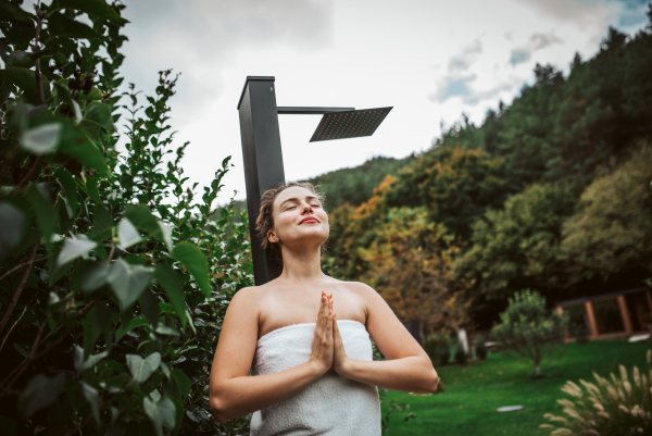 Beautiful woman meditating outdoor in the garden.. Woman taking care of her body and mind, wellness routine