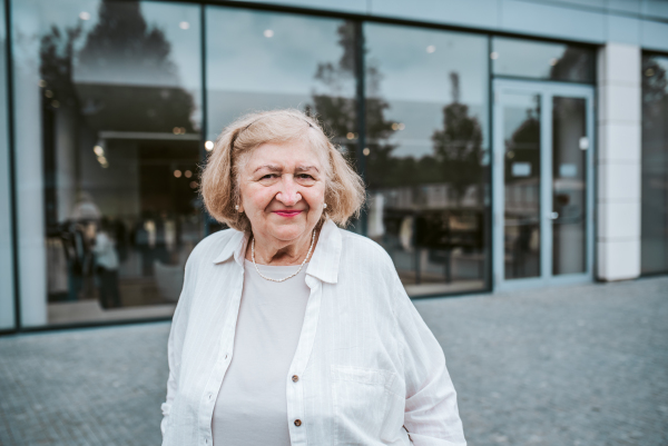 Portrait of older, senior woman on city street, running errands.