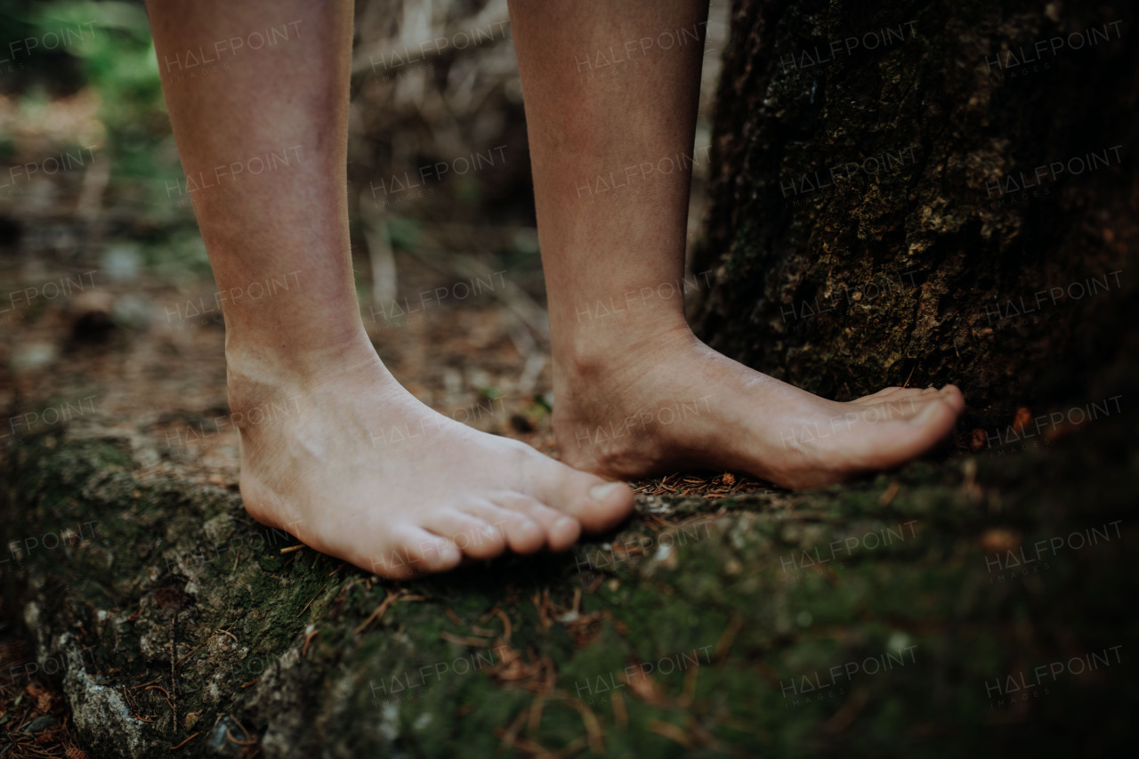 Close-up of barefoot legs walking in the nature. Concept of healthy feet.