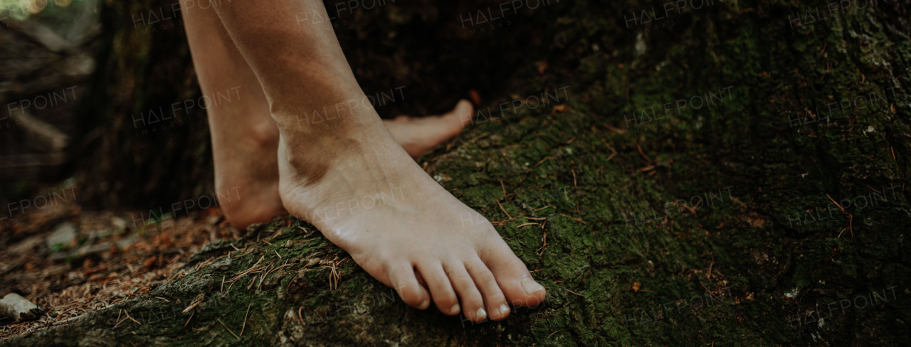 Close-up of barefoot legs walking in the nature. Concept of healthy feet.