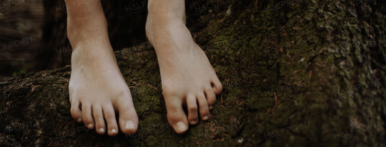 Close-up of barefoot legs walking in the nature. Concept of healthy feet.