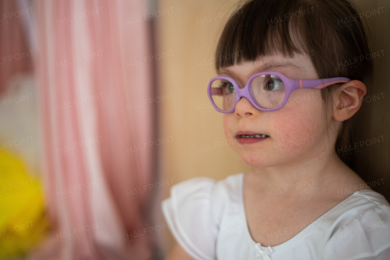 Little girl with down syndrome at a ballet class in dance studio. Concept of integration and education of disabled children.