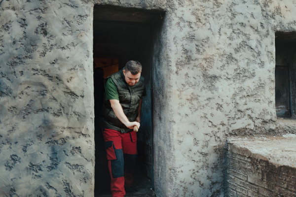 Caretaker with down syndrome in the cleaning animal enclosure. Concept of integration people with disabilities into society.