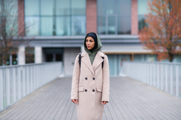 Young multiracial woman standing in city bridge.