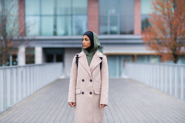 Young multiracial woman standing in city bridge.