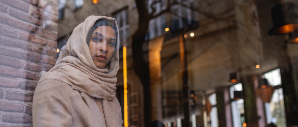 Portrait of young muslim woman in a cafe.