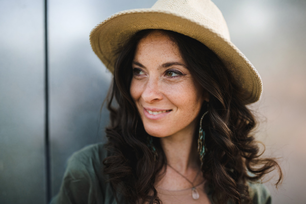 A woman candid portrait from street. Young urban female smiling looking at camera.