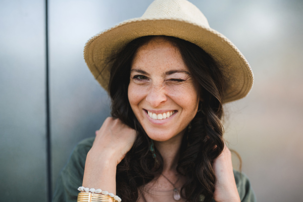 A woman candid portrait from street. Young urban female smiling looking at camera.