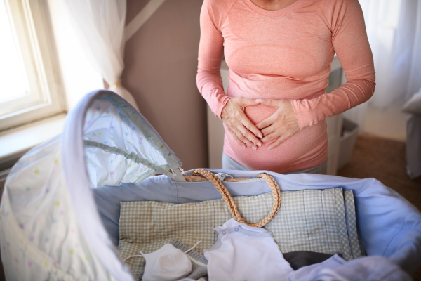 Close-up of a pregnant woman preparing for baby.