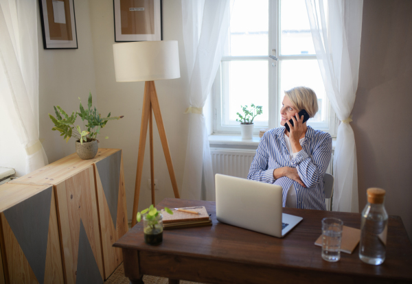 A pregnant woman having home office in the apartment.