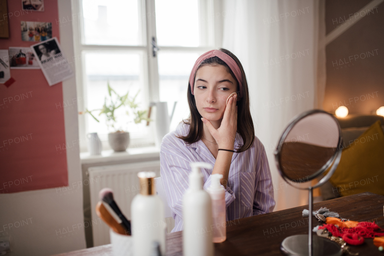 Teenage girl doing her skin care routine in the room.