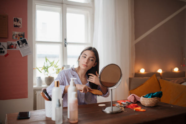 Teenage girl doing her skin care routine in the room.