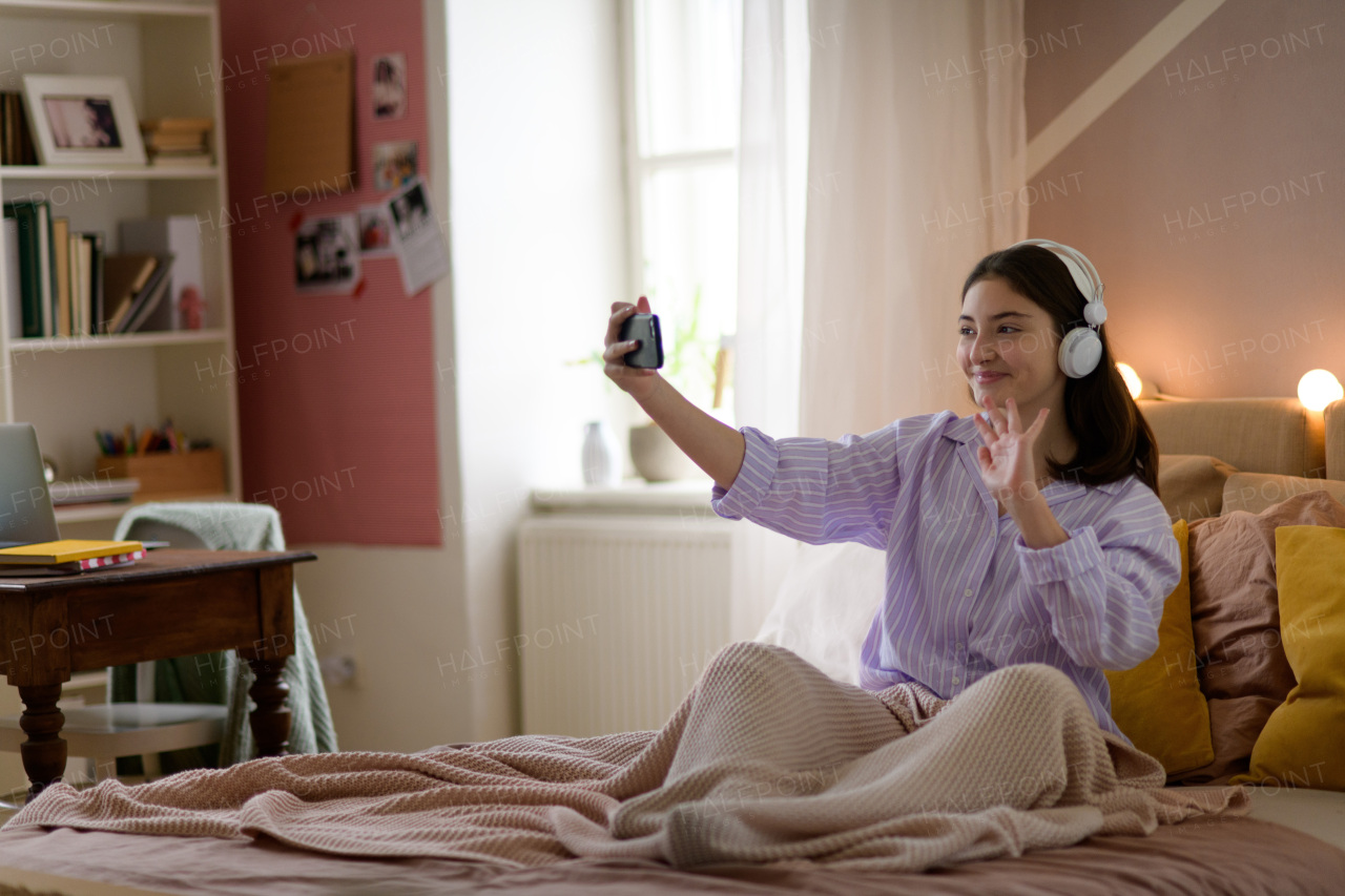 Young girl having video call in the room.