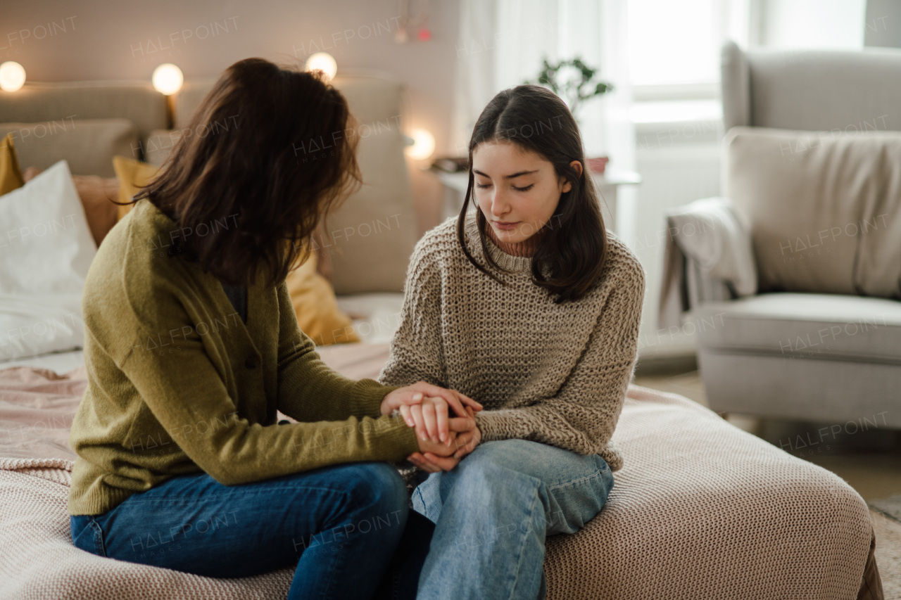 Teenage girl sharing problems with her mother in the room.