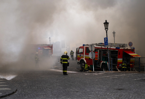 Close up of firemen in action in city center.