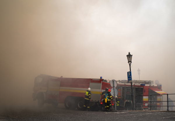 Close up of firemen in action in city center.