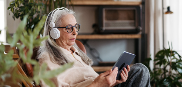 Senior woman spending her free time with a digital tablet.