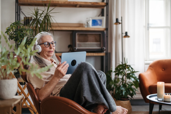 Senior woman spending her free time with a digital tablet.