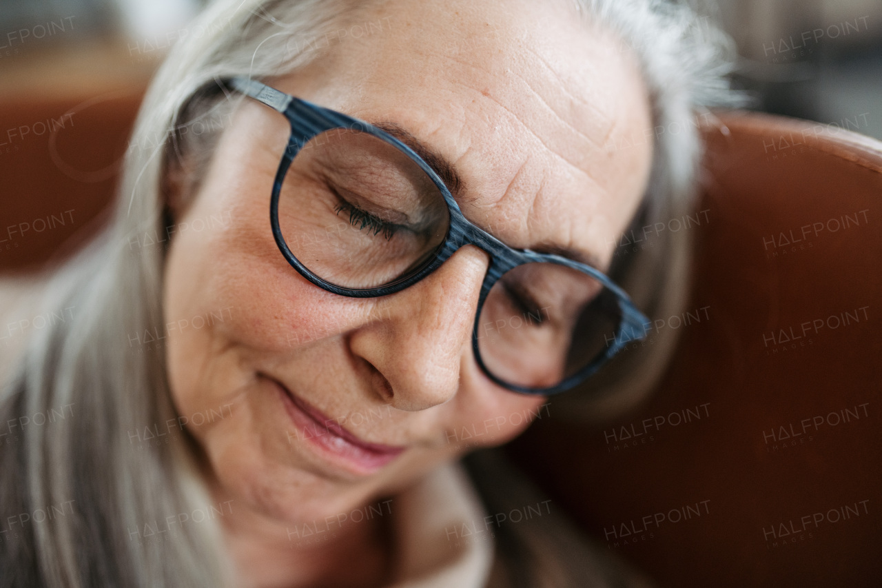 Portrait of senior woman resting in the apartment.