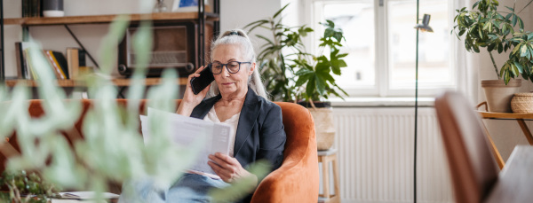 Portrait of senior businesswoman calling in the office.