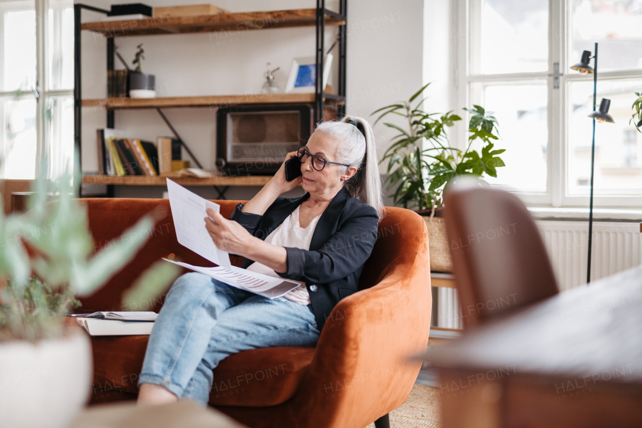 Portrait of senior businesswoman calling in the office.