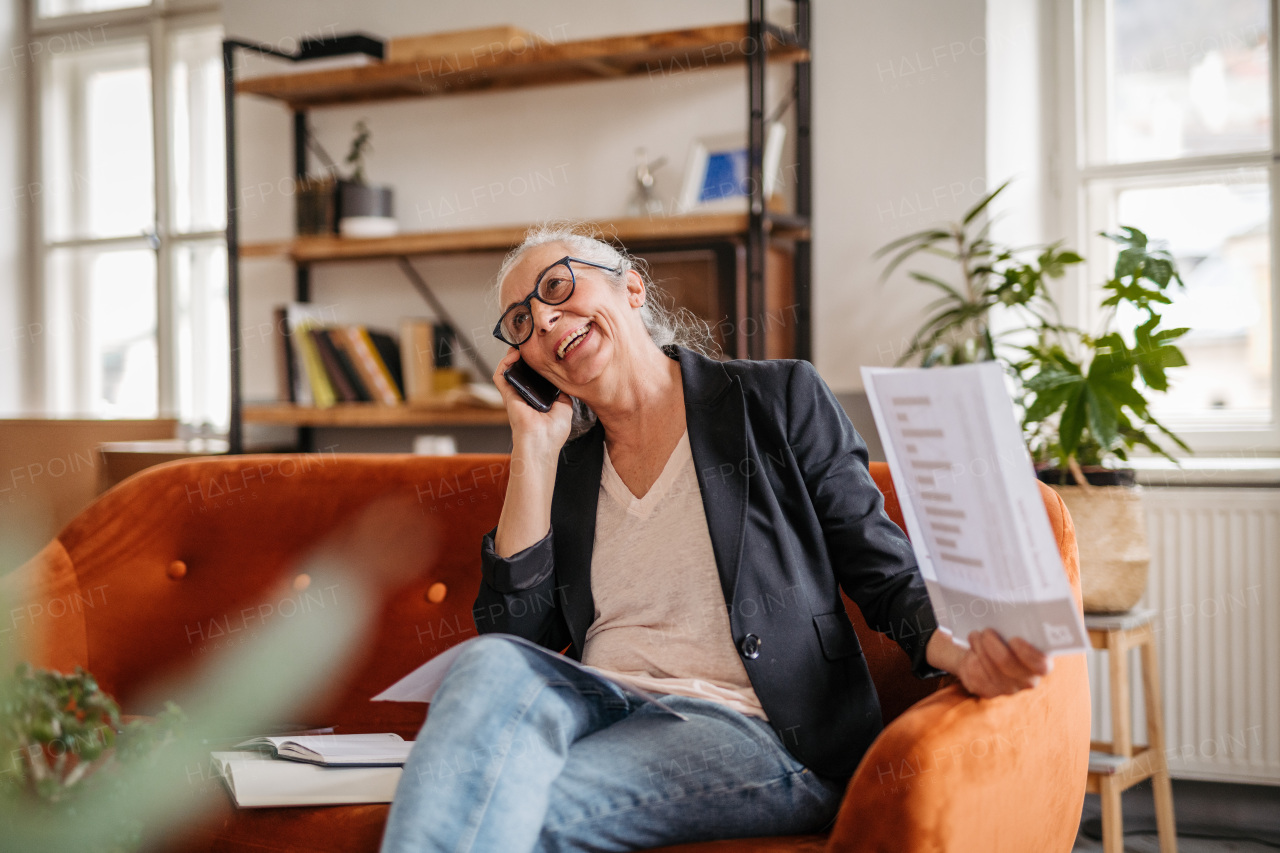 Portrait of senior businesswoman calling in the office.