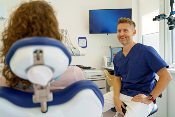 Dentist having consultation with patient in his modern ambulance.