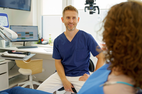 Dentist having consultation with patient in his modern ambulance.