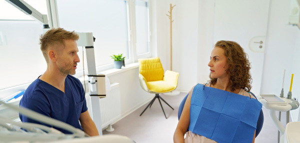 Dentist having consultation with patient in his modern ambulance.