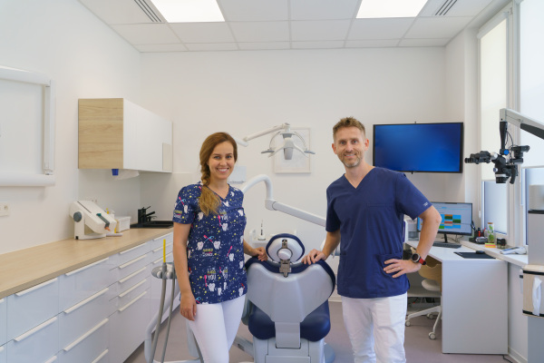 Dentist posing with a nurse in dentists ambulance.