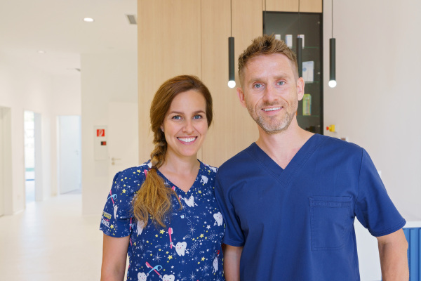 Dentist posing with a nurse in dentists ambulance.