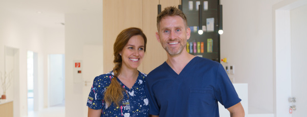 Dentist posing with a nurse in dentists ambulance.