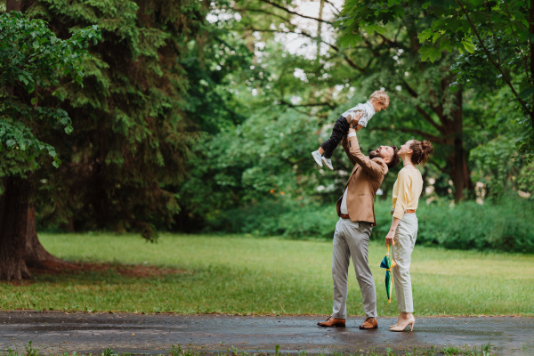 Young family with little son on a walk after work.