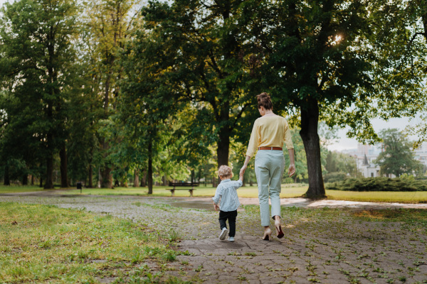 Young mother with little son on a walk after walk.