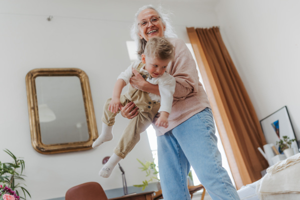 Senior woman having fun with little grandson.