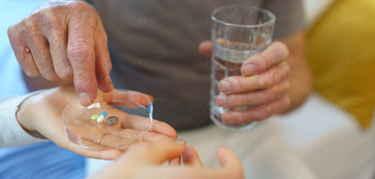 Close up of senior man taking medicines.