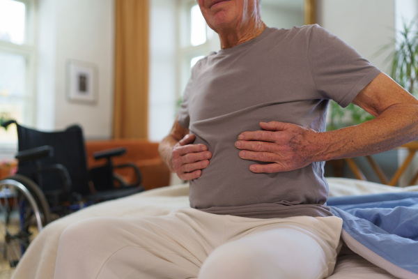 Close-up of senior man with pain in his stomach.