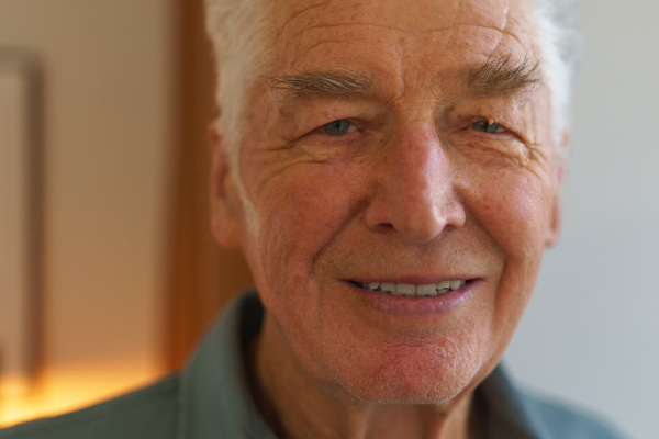 Portrait of smiling senior man at his home.