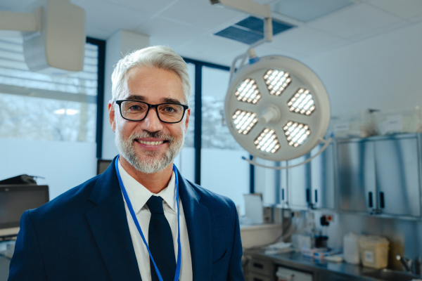 Portrait of pharmaceutical sales representative in medical building, waiting for doctor, presenting new pharmaceutical product. Hospital director, manger in private modern medical clinic.