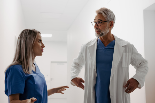 Conflict between doctors in hospital, different medical opinions or communication problems. Tense or uncomfortable work environment among healthcare workers. The nurse is angry with the doctor.