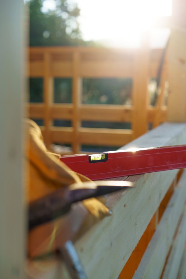 Close up of a construction tools inside of unfinished wooden house.