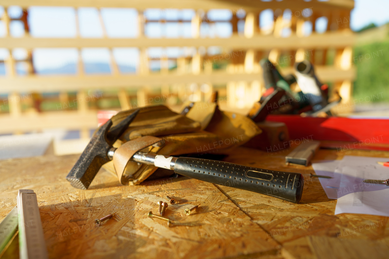 Close up of a construction tools inside of unfinished wooden house.