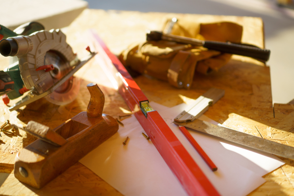 Close up of a construction tools inside of unfinished wooden house.