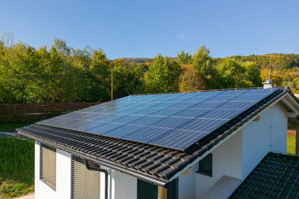 High angle view of solar photovoltaic panels on a roof, alternative energy, saving resources and sustainable lifestyle concept.