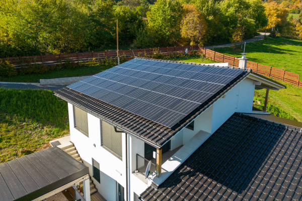 High angle view of solar photovoltaic panels on a roof, alternative energy, saving resources and sustainable lifestyle concept.