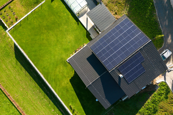 Top view of solar photovoltaic panels on a roof, alternative energy, saving resources and sustainable lifestyle concept.