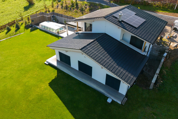 High angle view of solar photovoltaic panels on a roof, alternative energy, saving resources and sustainable lifestyle concept.