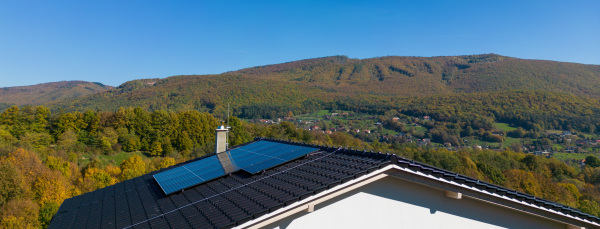 High angle view of solar photovoltaic panels on a roof, alternative energy, saving resources and sustainable lifestyle concept.